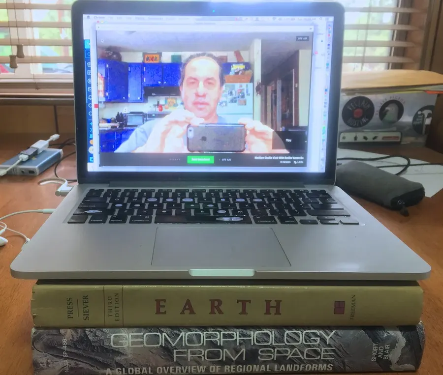 Laptop on a desk showing a live video call