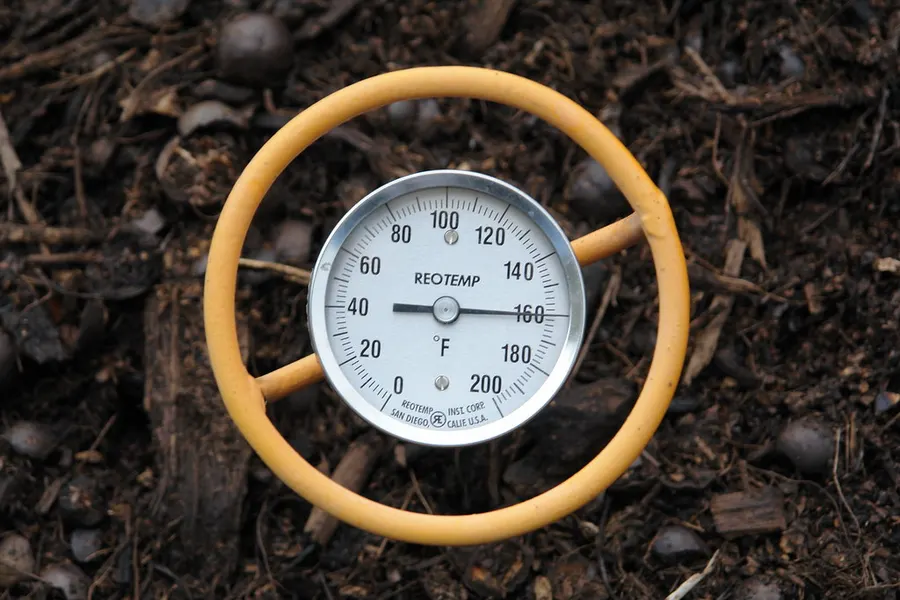 Thermometer measuring the heat of organic waste as it breaks down