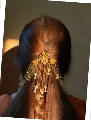 Legacy by Bisma gold hair jewellery on a braided ponytail